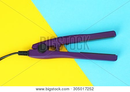 Modern Hair Iron For Straightening On Color Background, Top View