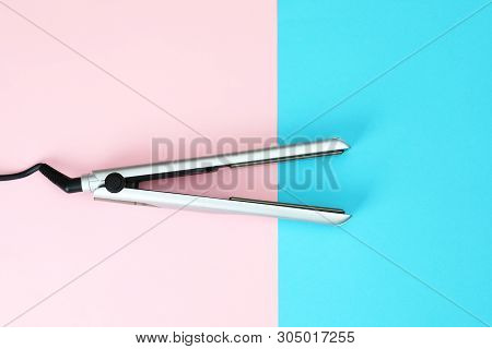 Modern Hair Iron For Straightening On Color Background, Top View