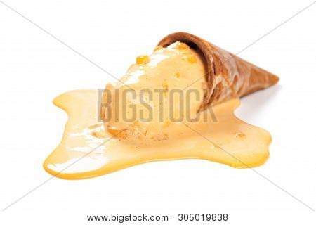 Side View Mango Flavor Ice Cream Cone In A Melting Process On White With Clipping Path