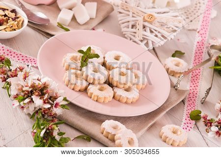 Canestrelli Biscuits With Icing Sugar On Wooden Table.