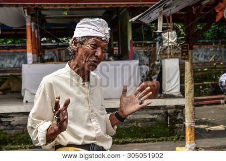 Bali, Indonesia - January 7, 2018:  Portrait Of Old Priest In Pura Dalem Segara Madhu, Balinese Hind