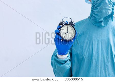 Male Surgeon Medical Specialist With A Clock.