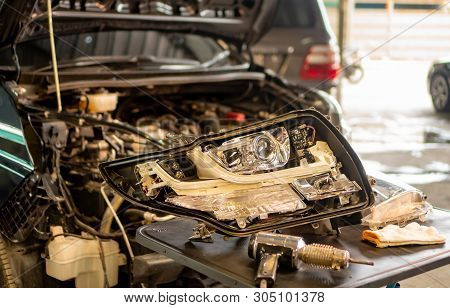 Car Mechanic, Doing Cleaning, The Headlight Of The Car, Installation And Turning Headlight Of Modern