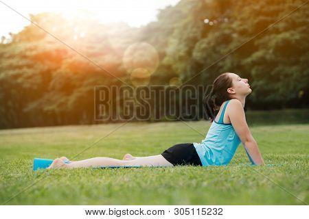 Woman Doing Yoga On The Park - Beautiful Lights.relax In Nature On The Park .