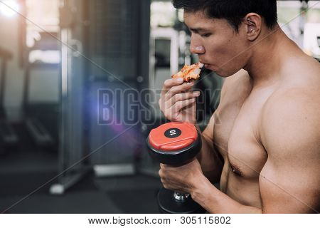 Strong Muscular Athlete Men With Pizza Fast Food. Unhealthy Eating Diet Concept.