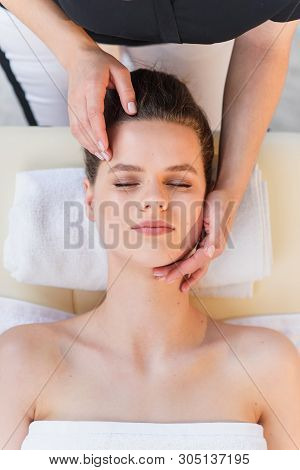 Young Female Masseur Making Massage For Young Client.