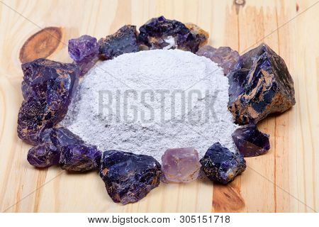 A Pile Of Fluorine Spar Surrounded By Fluorite Stones On Wood.