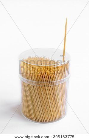 Bamboo Toothpicks In Plastic Box With Lid On White Background, One Toothpick Taken Out