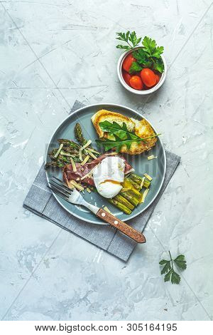 Green Asparagus And Boiled Poached Egg With Hamon (jamon) And Chopped Parmigiano (parmesan) On A Lig