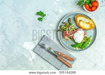 Green Asparagus And Boiled Poached Egg With Hamon (jamon) And Chopped Parmigiano (parmesan) On A Lig