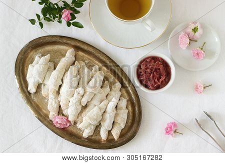 Traditional Romanian Or Moldavian Shortcake Cookies With Jam Stuffing And A Cup Of Tea On The Light 