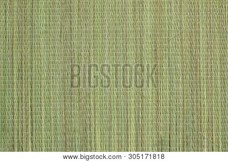 Wicker Bast Beach Mat Background. Texture Of Green Beach Mat Made Of Bast Fibers. The Surface Of The