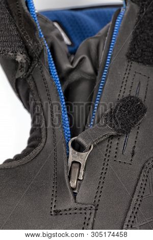 Detail Of The Zipper Of A Motorcycle Boot Isolated On White.