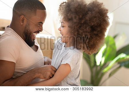 Cute African Kid Daughter Laughing Tickling Black Dad At Home