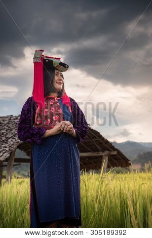 Portrait of Woman Tribal Lisu in Traditional Clothing in Rice Fields, Tribes Lisu Wearing Beautiful Tradition Clothes and Stand Posing in The Rice Terrace. Cultural Lifestyle of Hill Tribe Woman