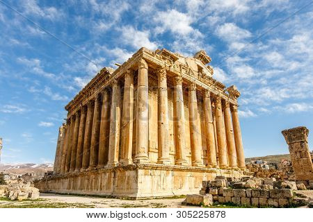 Ancient Roman Temple Of Bacchus With Surrounding Ruins And Blue Sky In The Background, Bekaa Valley,