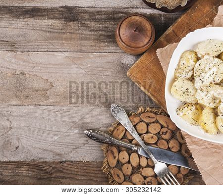 Boiled Potatoes On A White Plate. Dietary Food. Wooden Background, Wooden Cutlery. View From Above