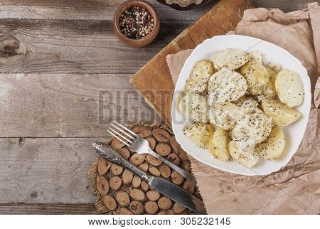 Boiled Potatoes On A White Plate. Dietary Food. Wooden Background, Wooden Cutlery. View From Above