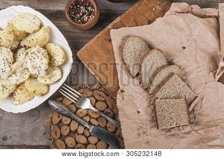 Boiled Potatoes On A White Plate. Dietary Food. Wooden Background, Wooden Cutlery. View From Above