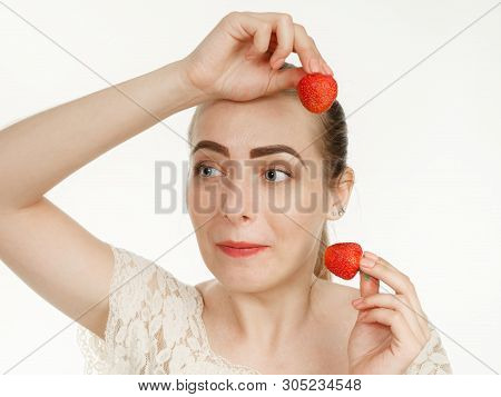 Beautiful Girl Makes Makeup Strawberry Berries On A White Background