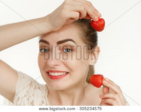 Beautiful Girl Makes Makeup Strawberry Berries On A White Background