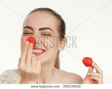 Beautiful Girl Makes Makeup Strawberry Berries On A White Background