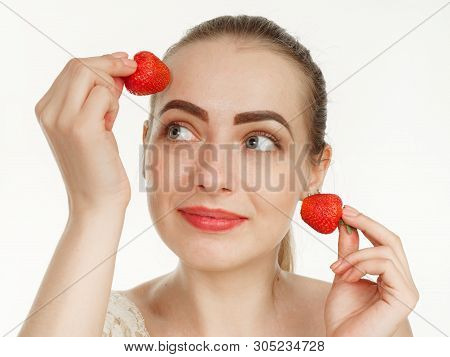 Beautiful Girl Makes Makeup Strawberry Berries On A White Background