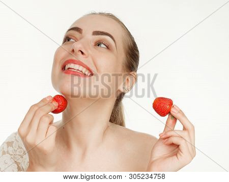 Beautiful Girl Makes Makeup Strawberry Berries On A White Background