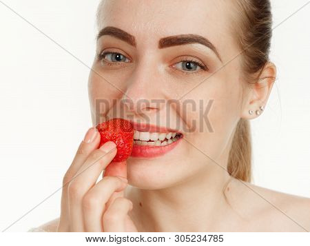 Beautiful Girl Makes Makeup Strawberry Berries On A White Background