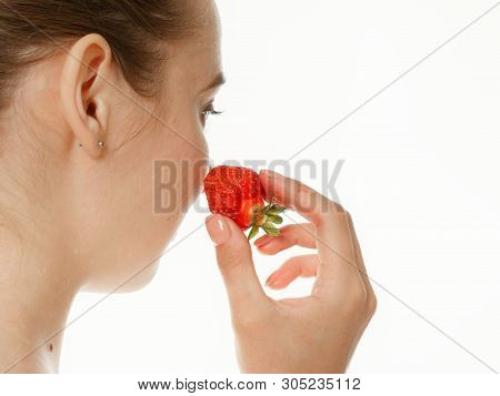 Beautiful Girl Makes Makeup Strawberry Berries On A White Background