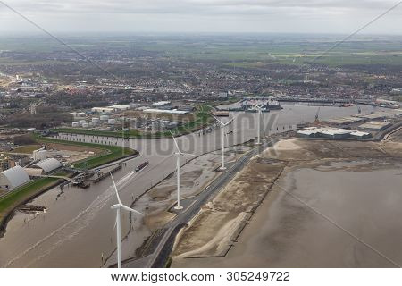Aerial View Harbor Delfzijl With Wind Turbines And Factories In The Netherlands