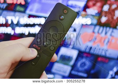 Sankt-petersburg, Russia, March 30, 2019: Man Holds In His Hand Remote Control With Netflix Button. 