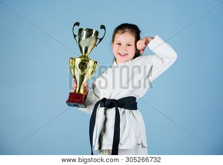 Practicing Kung Fu. Happy Childhood. Small Girl With Champion Cup. Martial Arts. Sport Success In Si