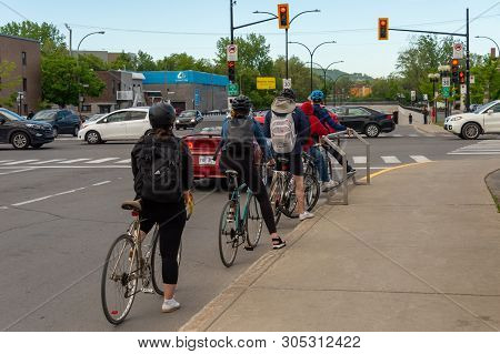 Montreal, Canada - 7 June 2019: Cyclists Waiting At A Red Light On Masson Street
