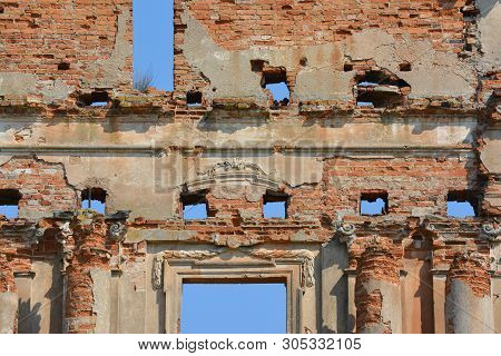 Ruins Of Ancient Palace In Pruzhany, Belarus Made Of Red Brick With The Blue Sky Instead Of Windows.