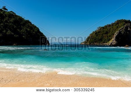 View Of Tropical Beach, Sea Rocks And Turquoise Ocean, Blue Sky. Atuh Beach, Nusa Penida, Indonesia