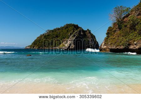 View Of Tropical Beach, Sea Rocks And Turquoise Ocean, Blue Sky. Atuh Beach, Nusa Penida, Indonesia
