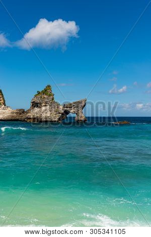 View Of Tropical Beach, Sea Rocks And Turquoise Ocean, Blue Sky. Atuh Beach, Nusa Penida, Indonesia
