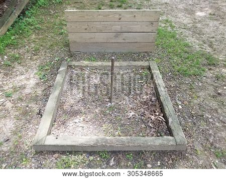 Horseshoe Pit With Metal Pole And Wood Backstop