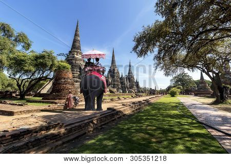 Foreign Tourists Elephant Ride To Visit Ayutthaya, There Are Ruins And Temple In The Ayutthaya Perio