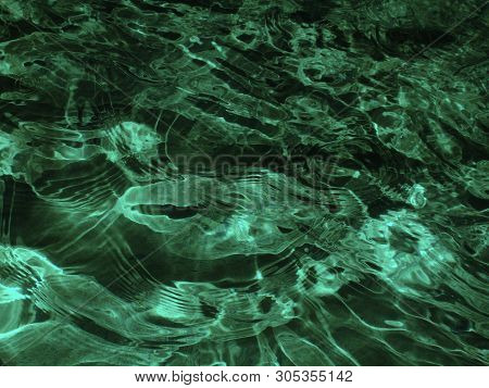 Water Fountain Waves.  Green Water In Fountain. Background, Night. Water Ripples Over Stone. Ripple 