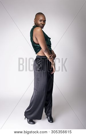 Black African American Female Fashion Model Posing With Trendy Bald Hairstyle And Stylish Clothing I