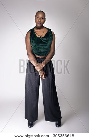 Black African American Female Fashion Model Posing With Trendy Bald Hairstyle And Stylish Clothing I