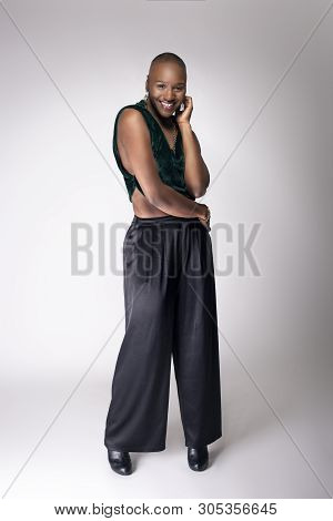 Black African American Female Fashion Model Posing With Trendy Bald Hairstyle And Stylish Clothing I