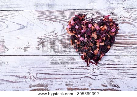 Dry Mix Of Fruit Tea Forming A Heart On The White Table