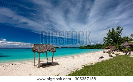 Amazing Port Orly sandy beach with palm trees, Espiritu Santo Island, Vanuatu.