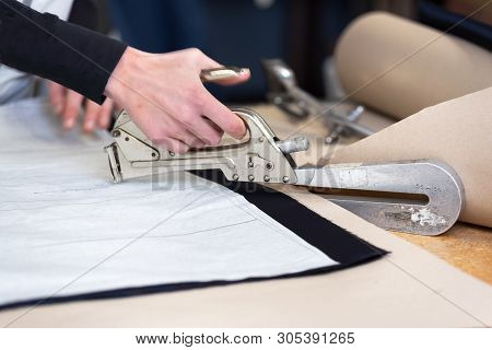 Dressmaker Designer Stapling Fabric Pattern At Garment Industry .