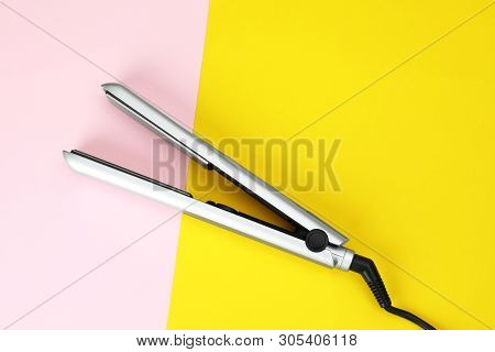 Modern Hair Iron For Straightening On Color Background, Top View