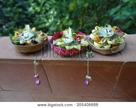 Close Up Picture Of Three Typical Balinese Offerings (canang Sari) On A Wall In Ubud Village, Bali, 