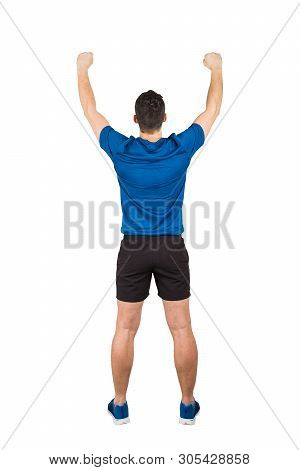Rear View Full Length Of Young Man Athlete With Hands Raised, Celebrating Victory. Self Overcome Con